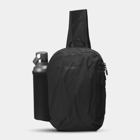 Gomatic Navigator Collapsible Sling 6L Black Front View With Straps and Water Bottle